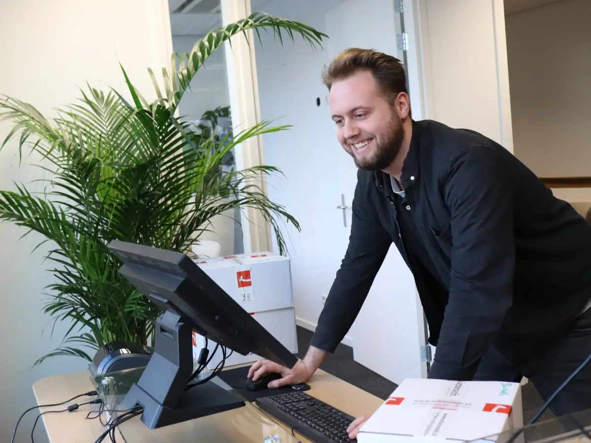 Medewerkers van de Microcash-helpdesk helpen klanten vanuit Den Haag